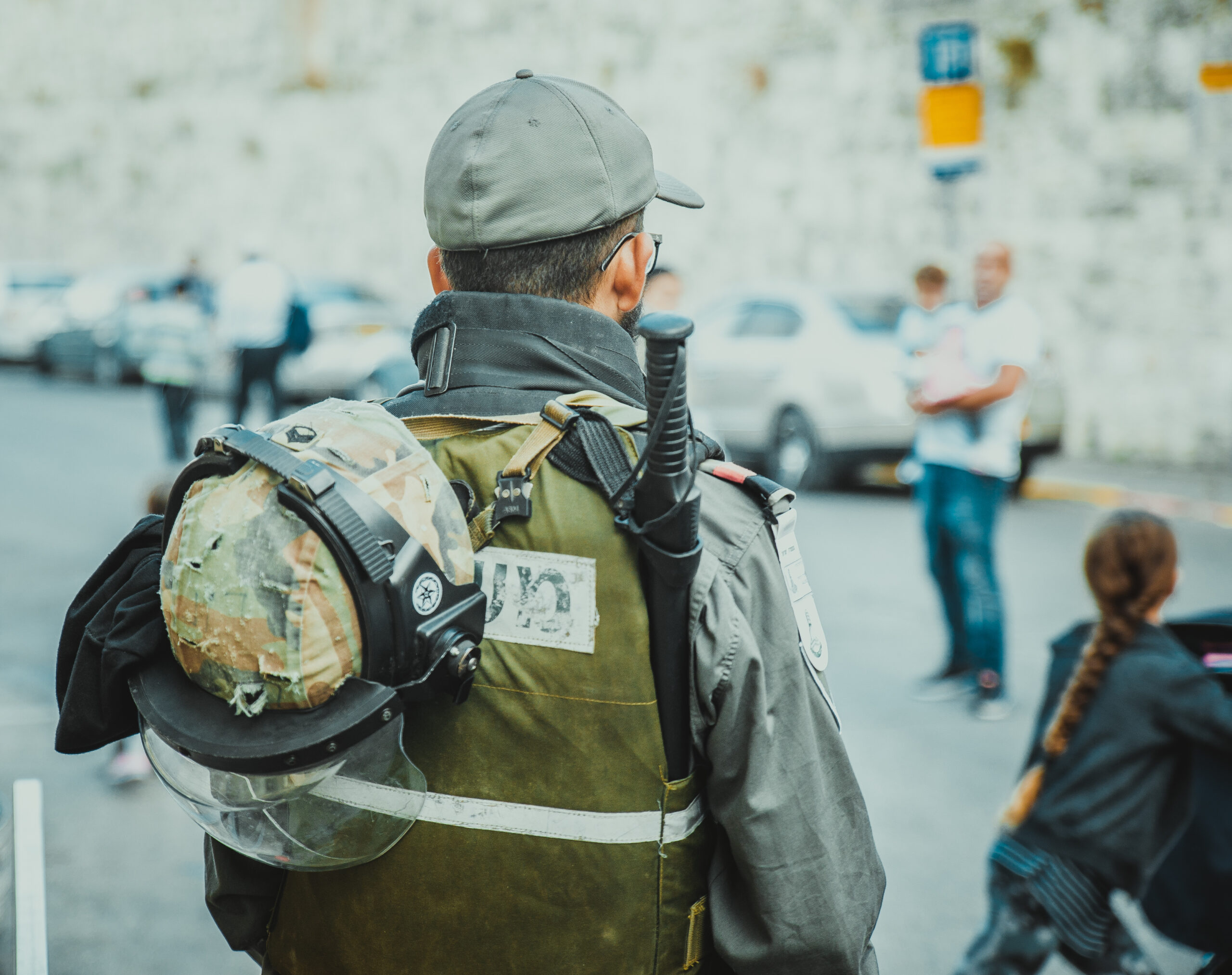 Soldier standing among a gathering of people